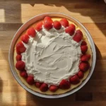 Sour Cream being added to a box cake mix batter in a mixing bowl.