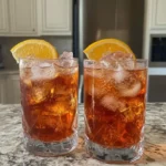 A close-up shot of an aperol spritz recipe 3-2-1 in a glass with an orange slice.